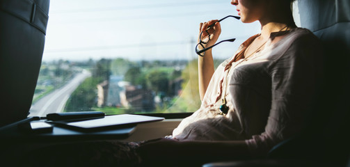 Woman traveling by train at window