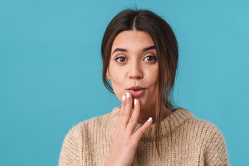 Image of young cute woman expressing surprise and looking at camera