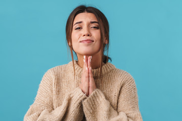 Image of young beautiful woman posing with palms together