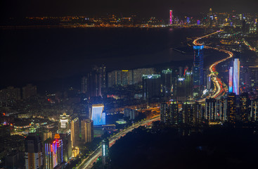 Fototapeta na wymiar orange illuminated Shenzhen highway on waterfront