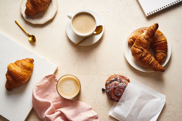 Flatlay with coffee and croissants. Breakfast beverage with pastry. Morning set