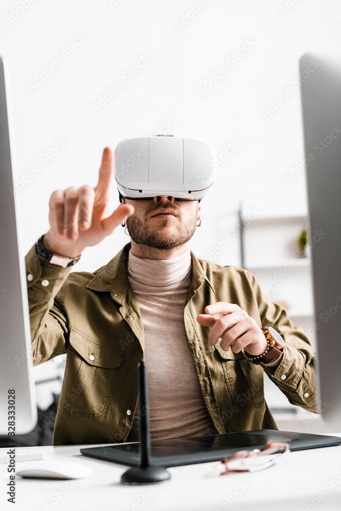 Aufkleber selective focus of digital designer in virtual reality headset pointing with finger near graphics ta