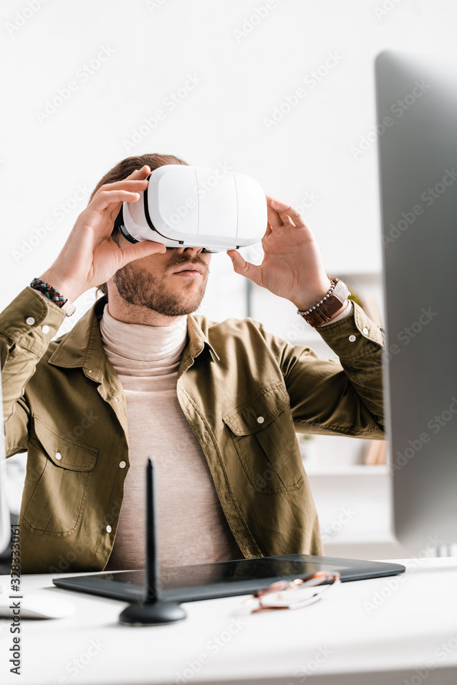 Aufkleber selective focus of 3d artist using virtual reality headset near graphics tablet and computer on tabl