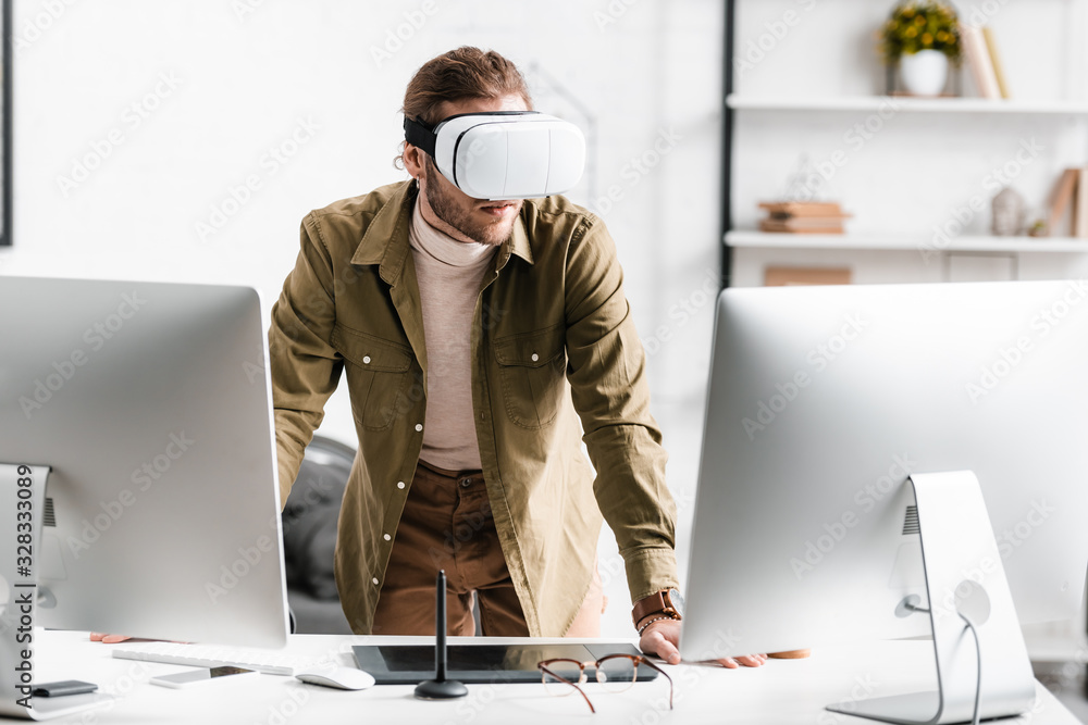 Aufkleber digital designer in virtual reality headset standing near computers and graphics tablet on table