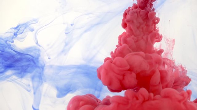 Water aquarium tank with some blue ink, more red ink sprayed from syringe - abstract background