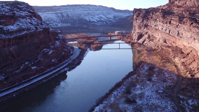 Aerial Flyover of Colorado River Near Moab, Utah U.S.A. Following Car Approaching Bridge on Highway 191 by Drone