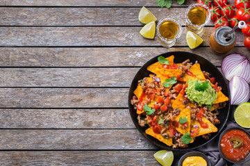 Chips nachos with beef, guacamole, chili, cheese salsa, tequila