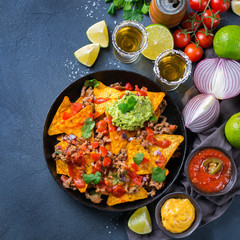 Chips nachos with beef, guacamole, chili, cheese salsa, tequila