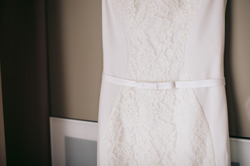 belt with a bow on a white lace wedding dress