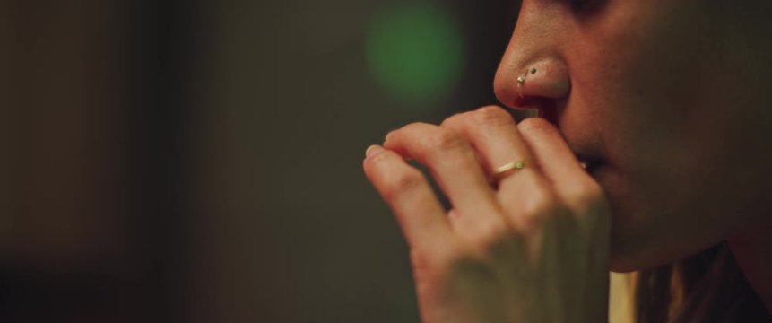 Young woman wiping her nose from nosebleed, feeling scared. Horror concept. BMPCC 4K