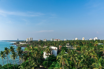 Fototapeta premium Kerala Travel and Tourism Concept Image, Amazing Panoramic nature view of Kannur, Best place to visit, Green Coconut Trees with blue sea and sky