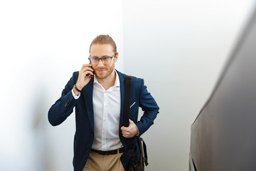 Businessman indoors walking by upstairs