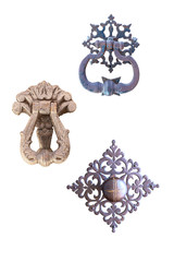 three old metal door handle with a beautiful metal ornament isolated on a white background