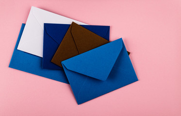 Colorful envelopes on a pink background.