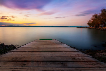sunset on lake with a jetty in the water at Lake Balaton in Hungary,