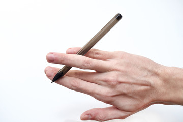 Young male hand holds a black pen on a white background