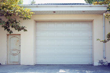 Shutter door or roller door and concrete floor outside .White Automatic shutters in a house . gates in the garage . Automatic Electric Roll-up Gate Or Push-up Door In The Modern Building .