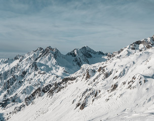 European winter sports Alps - snowy peaks, mountains and ski slopes with cloudy skies near St. Anton am Arlberg