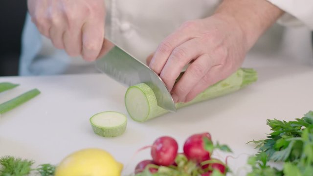 chef cutting vegetables zucchini