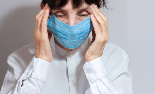 Coronavirus quarantine and Air pollution pm2.5 concept. Sick sad depressed, thoughtful old woman wearing respirator mask for protect. Wuhan, China epidemic virus symptoms background.