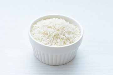 Natural raw white rice grains, on display in bowl