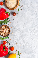 Healthy food. Vegetables, lemon and chickpeas on a concrete background, top view, free space for text. Vegetarian and vegan food concept, copy space. Raw food for cooking Mediterranean cuisine.