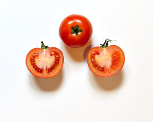 Group of fresh red tomatoes isolated in a white background viewed from above