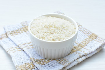 Natural raw white rice grains, on display in bowl