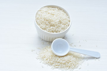 Natural raw white rice grains, on display in bowl