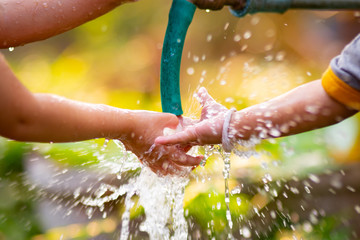 Kids washing hand and make water splashing. Concepts for save water and playing in children.