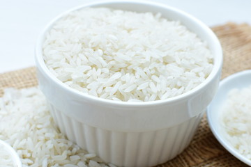 Natural raw white rice grains, on display in bowl