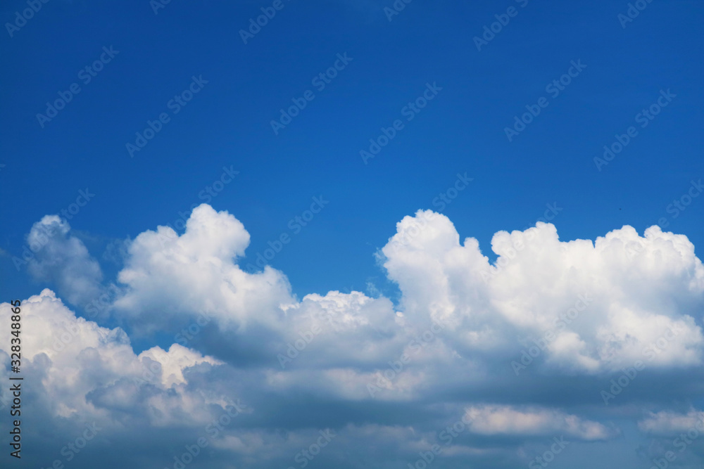 Wall mural pure white heap cloud and sunlight shining and pass on blue sky