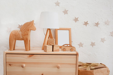 Stylish scandinavian newborn baby room with wooden toys and lamp. zero waste. eco-friendly materials