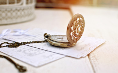 Vintage open pocket watch and antique letter. Retro still life.