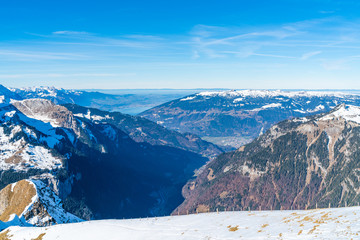 View of snow covered Swiss Alps from Mannlichen summit in Grindelwald ski resort. Winter in Switzerland