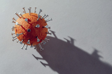 Close-up concept of virus is depicted in form of orange with wood screws