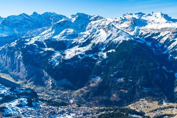 Aerial view of Grindelwald ski resort and snow covered Swiss Alps from Mannlichen summit. Winter in Switzerland