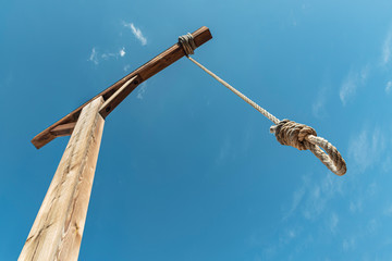 Gallows against blue sky. Hanging rope as a way to punishment - obrazy, fototapety, plakaty