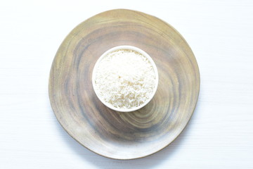 Natural raw white rice grains, on display in bowl