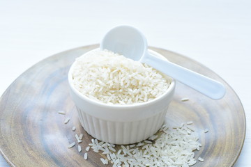 Natural raw white rice grains, on display in bowl