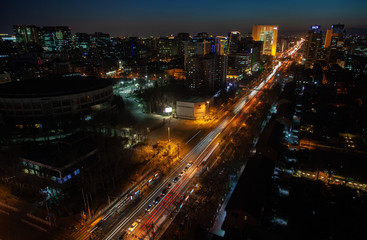 Fototapeta na wymiar Chinese buildings surround wide Beijing highway 