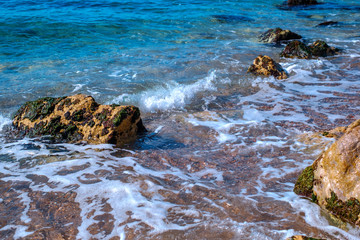 small waves on the shore with stones, Athens, Greece
