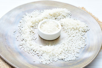 Natural raw white rice grains, on display in bowl