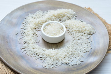 Natural raw white rice grains, on display in bowl