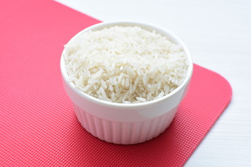 Natural raw white rice grains, on display in bowl