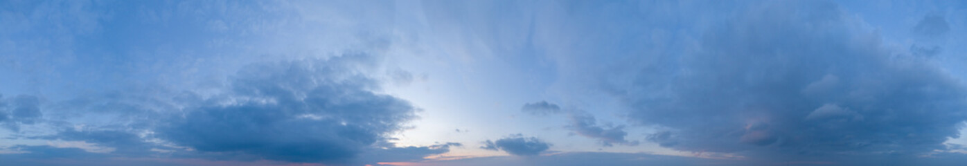 Large panorama of evening sunset sky with beautiful clouds.