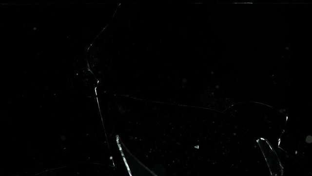Super slow motion of shattered glass on black background. Filmed on high speed cinema camera, 1000 fps.