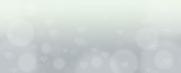 Abstract gray bokeh banner background with hearts - birthday, father's day, valentine's day panorama - blurry bokeh circles and hearts on a gray background.