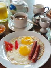 Breakfast in Sri Lanka. Scrambled eggs with sausages and coffee