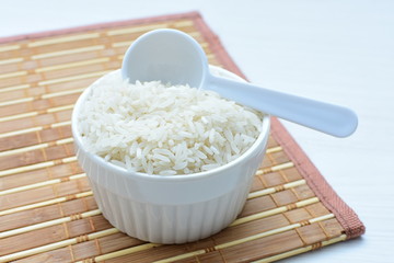 Natural raw white rice grains, on display in bowl